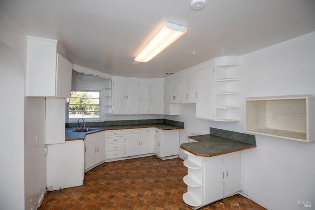 kitchen with white cabinetry and sink