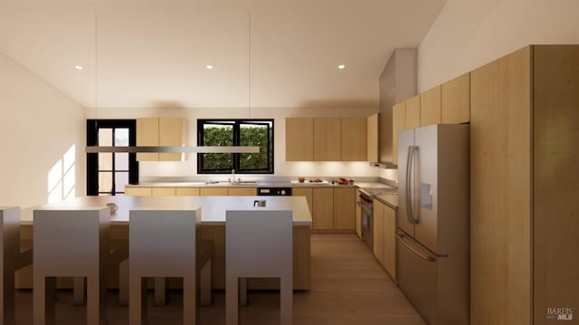 kitchen featuring modern cabinets, light brown cabinets, a sink, stainless steel appliances, and light countertops