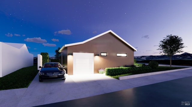 view of front of property featuring an outdoor structure, concrete driveway, and a garage