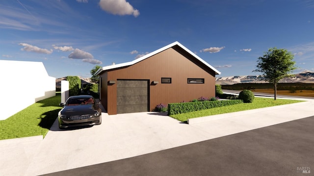 view of home's exterior with an outbuilding, concrete driveway, and a detached garage