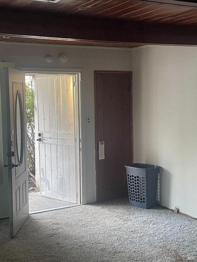 entryway with wood ceiling, beam ceiling, and carpet flooring