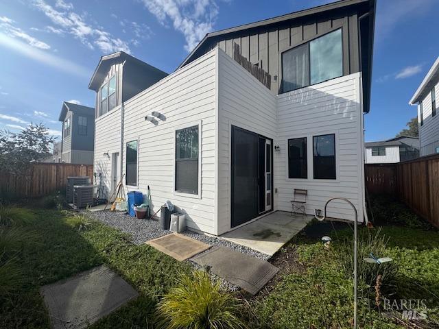 back of property featuring central AC and a patio area