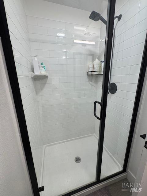 bathroom with a shower with shower door