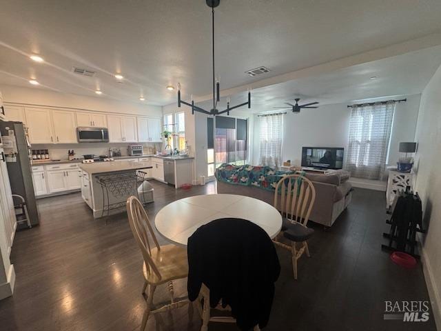 dining space featuring ceiling fan, dark hardwood / wood-style flooring, and sink