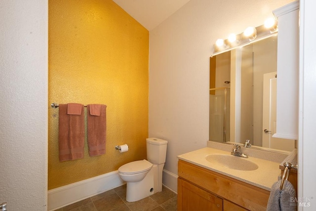 bathroom featuring lofted ceiling, vanity, tile patterned floors, toilet, and walk in shower