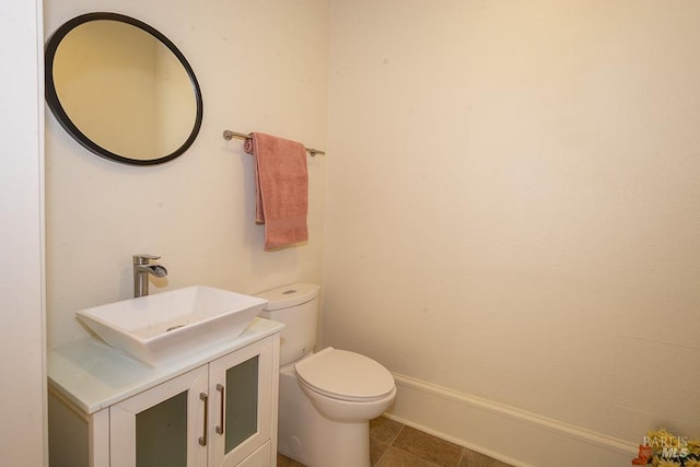 bathroom featuring vanity, tile patterned floors, and toilet