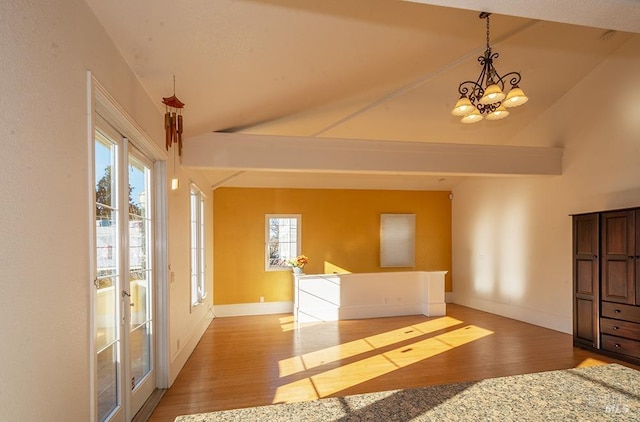 interior space featuring vaulted ceiling, a chandelier, and light hardwood / wood-style flooring