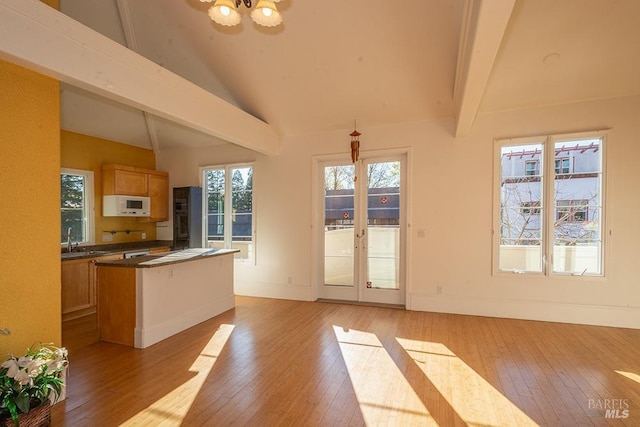 interior space featuring a wealth of natural light, light hardwood / wood-style floors, and french doors