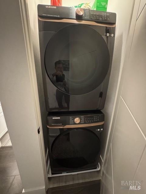 laundry area featuring stacked washer / drying machine