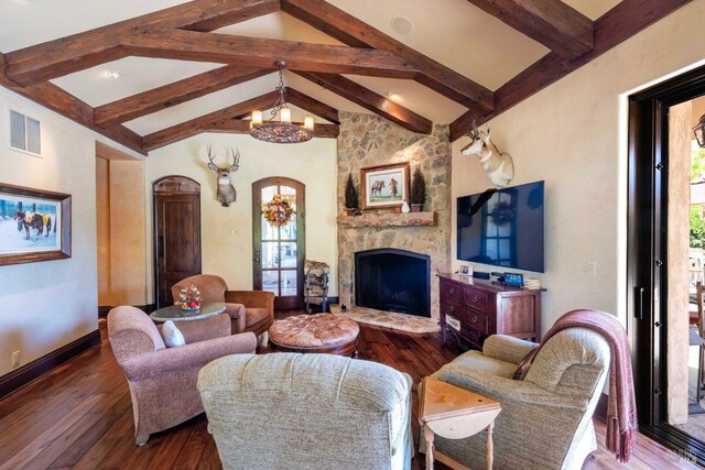 living room featuring dark wood-type flooring, a healthy amount of sunlight, and a notable chandelier