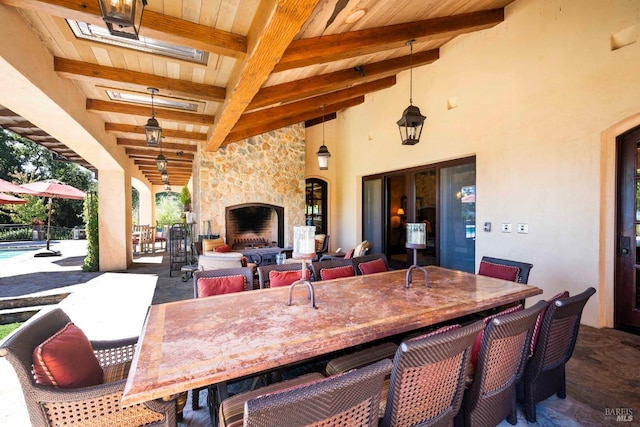 view of patio featuring an outdoor stone fireplace