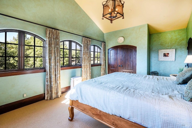 bedroom with vaulted ceiling, a chandelier, carpet floors, and multiple windows