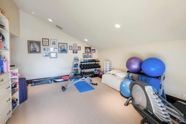 exercise area featuring vaulted ceiling and carpet