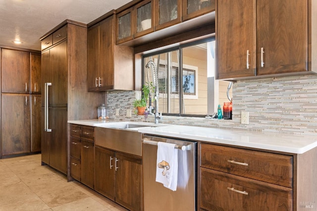 kitchen featuring dishwasher and backsplash