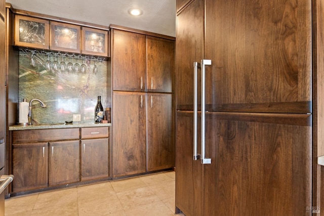 kitchen with light stone countertops and sink