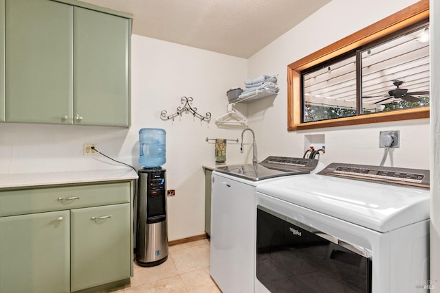 washroom featuring cabinets, ceiling fan, light tile patterned floors, and independent washer and dryer