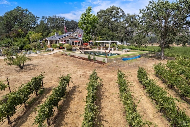 view of play area with a pool and a pergola