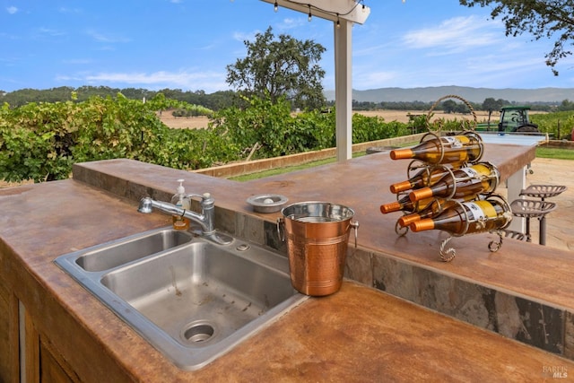 view of patio / terrace with a mountain view and sink