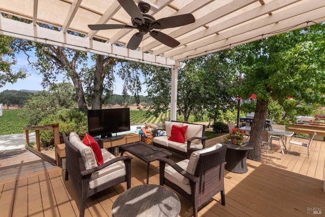 wooden terrace with a pergola, an outdoor hangout area, and ceiling fan