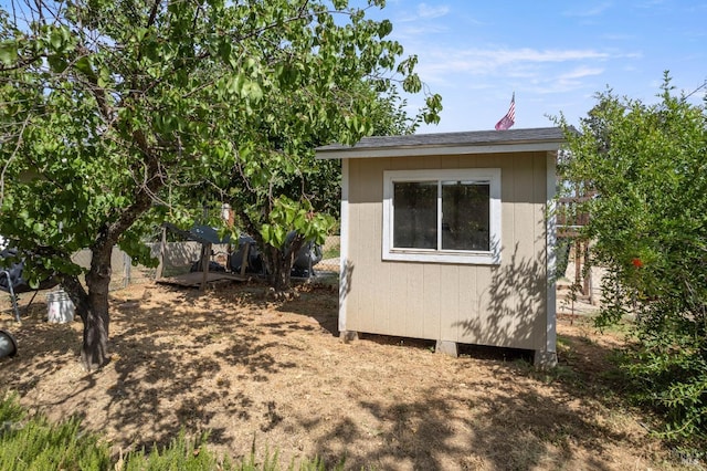 view of side of property featuring a shed