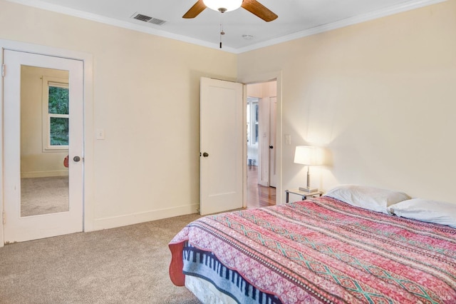 bedroom with light carpet, ornamental molding, and ceiling fan