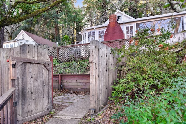 view of gate featuring a storage unit