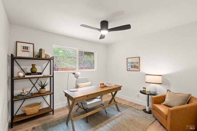 office with hardwood / wood-style flooring and ceiling fan