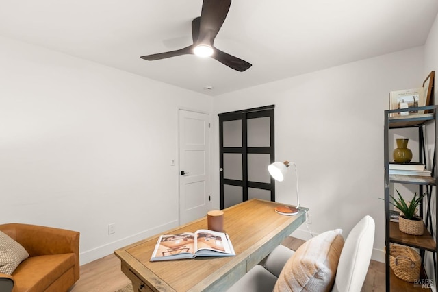 office area featuring light hardwood / wood-style flooring and ceiling fan