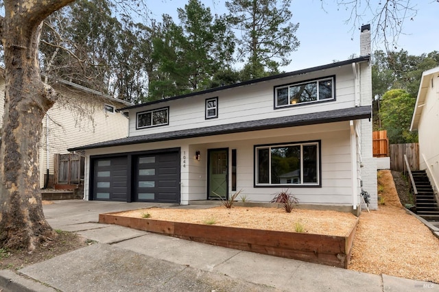 view of front facade with a garage and covered porch