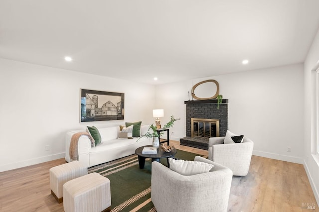 living room featuring a fireplace and light hardwood / wood-style flooring