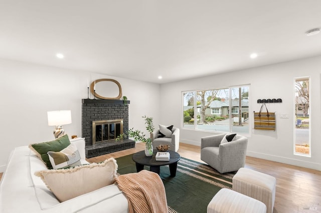 living room with a fireplace and light hardwood / wood-style floors