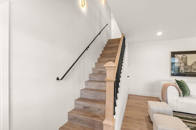 stairs featuring hardwood / wood-style flooring