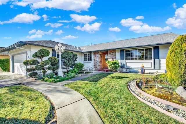 ranch-style home featuring concrete driveway, a front yard, brick siding, and an attached garage