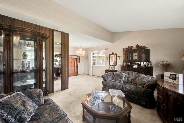 living area featuring an inviting chandelier and light colored carpet