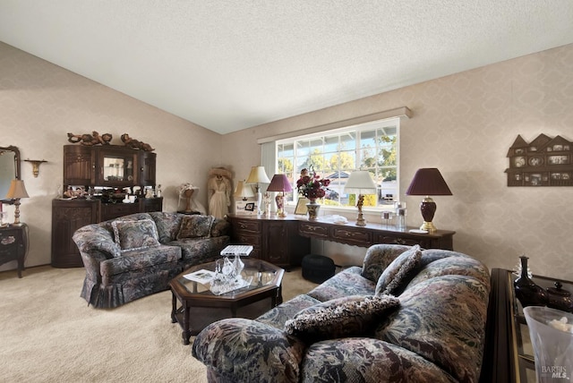 living area with wallpapered walls, a textured ceiling, light carpet, and lofted ceiling