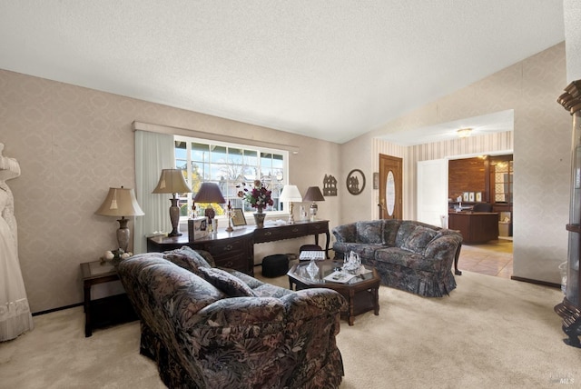 living area featuring wallpapered walls, a textured ceiling, carpet, and lofted ceiling