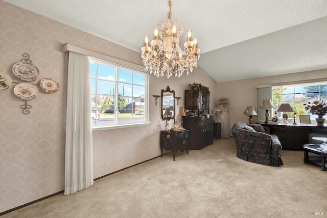 living area featuring a textured ceiling, vaulted ceiling, a chandelier, carpet flooring, and wallpapered walls