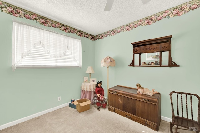 game room featuring ceiling fan, carpet flooring, baseboards, and a textured ceiling