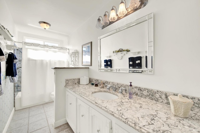 bathroom with shower / tub combo, toilet, vanity, and tile patterned floors