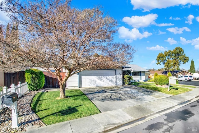 view of front of property featuring driveway, a garage, fence, and a front lawn