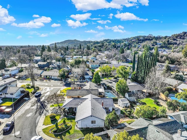 drone / aerial view featuring a residential view and a mountain view