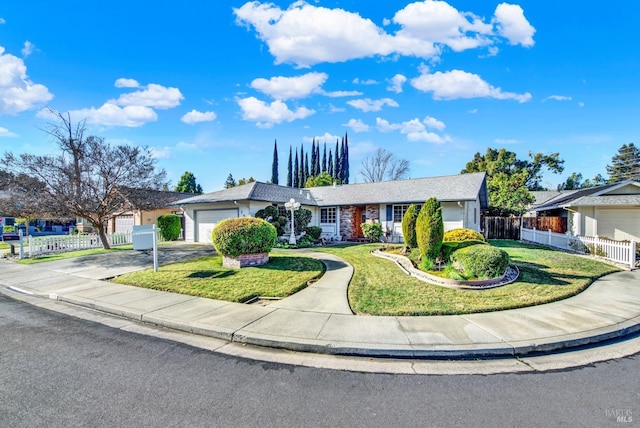 ranch-style home with a front yard, fence, a garage, and concrete driveway