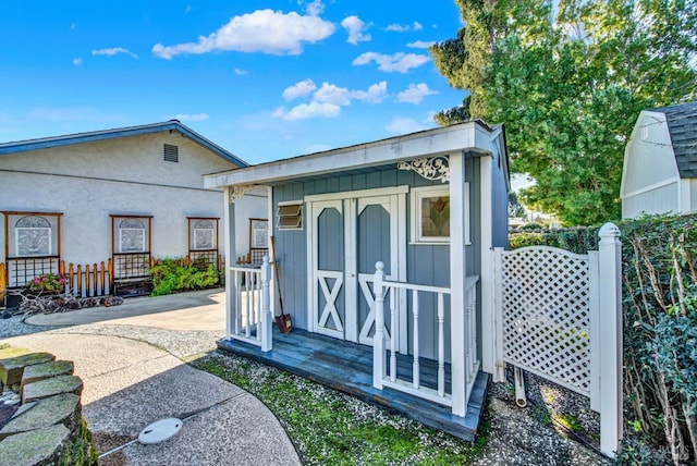 view of outbuilding with an outbuilding and fence