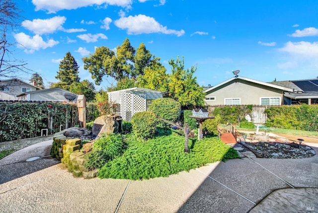 view of side of home featuring stucco siding and fence