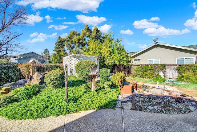 view of front of property featuring fence and stucco siding