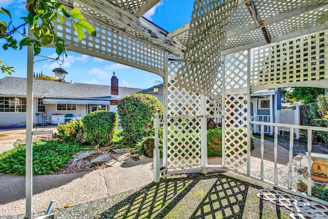 view of patio with a pergola and fence