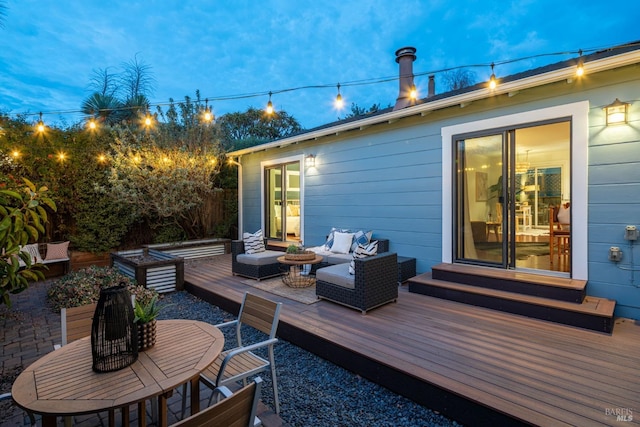 deck at dusk featuring an outdoor living space