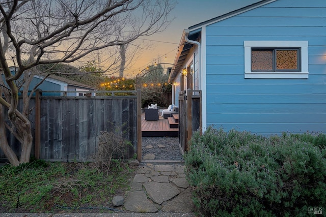 property exterior at dusk with a wooden deck