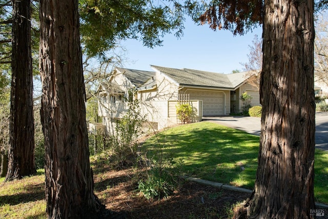 view of front of home with a garage and a front lawn