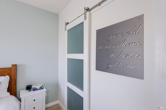 interior space with baseboards and a barn door